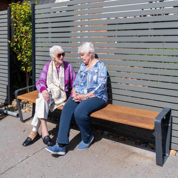 Two ladies sitting on Felton Ribbon bench seat